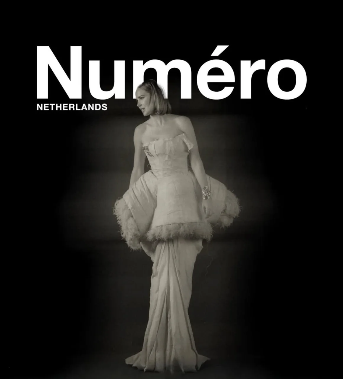 Arielle Kebbel in a feather-trimmed ivory gown on the cover of Numéro Netherlands